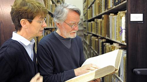 Two scholars studying a centuries-old text